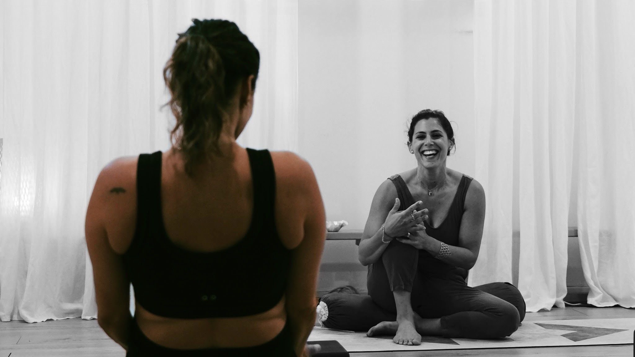 Maya laughing in a quiet studio